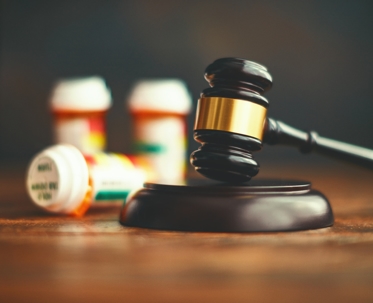 legal gavel and prescription bottles